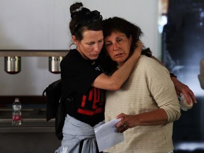 Liat Atzili Beinin (r), a 49-year-old resident of Nir Oz who was held hostage for 54 days in Gaza, where her husband's murdered body still remains, hugged by a member of the Hostages and Missing Families Forum, on April 11.