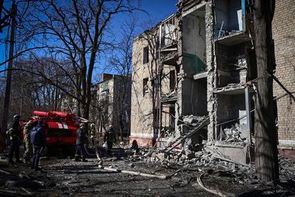 Ukrainian Emergency Service rescuers work on a building damaged by shelling in Kramatorsk, Donetsk region, Ukraine, on March 14, 2023.