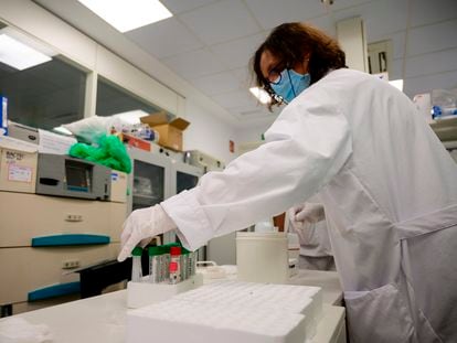 A scientist handles a PCR coronavirus tests at the microbiology laboratory of the Gregorio Maranon General Hospital in Madrid.