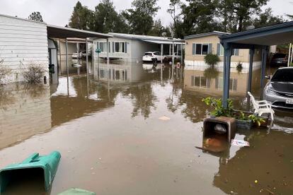 In this photo provided by Juan Reyes, homes are surrounded by floodwaters at the Arbor Mobile Home Park where he lives in Acampo, Calif., Sunday, Jan. 15, 2023.