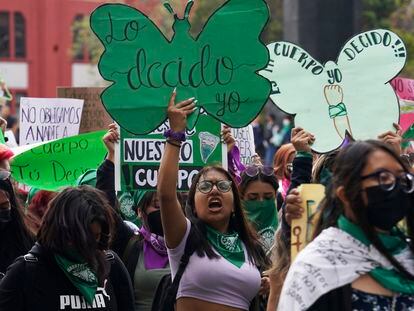A woman holds up a sign with a message that reads in Spanish; "I will decide" as she joins a march demanding legal, free and safe abortions for all women, marking International Safe Abortion Day, in Mexico City, Sept. 28, 2022