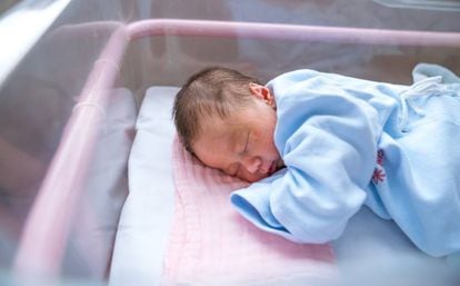 A newborn in his hospital cradle.