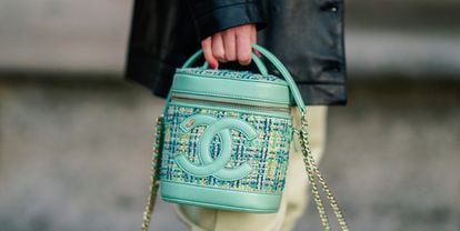 A green Chanel bag with embroidered logo and two parts made of tweed and leather is photographed in Paris, France.