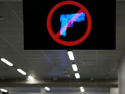 A television displays a "no guns" sign at the Transportation Security Administration security area at the Hartsfield-Jackson Atlanta International Airport on Wednesday, Jan. 25, 2023, in Atlanta.