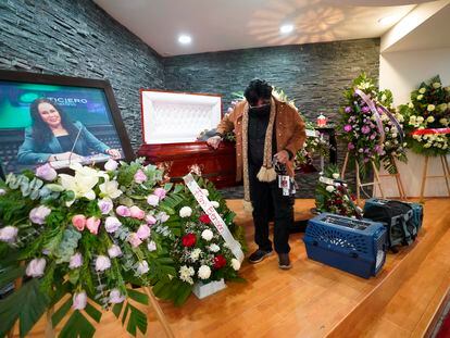 A friend pays his final respects to murdered journalist Lourdes Maldonado who was shot dead in her car when arriving home, in Tijuana, Mexico, Jan. 27, 2022.