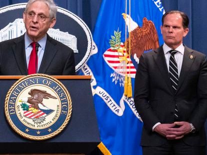 DEA Principal Deputy Administrator Louis Milione, right, stands behind Attorney General Merrick Garland during the announcement of an international law enforcement operation targeting fentanyl and opioid traffickers on the Darknet during a news conference at the Department of Justice, Tuesday, May 2, 2023, in Washington.