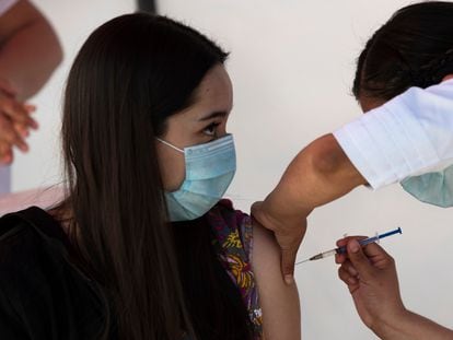 A health worker gets a shot of the Pfizer-BioNTech vaccine in Mexico City on December 30.