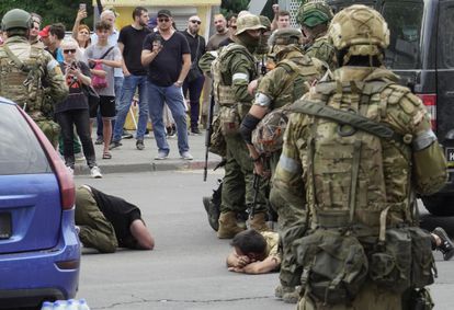 Wagner members detain several civilians blocking a street in Rostov, Saturday. 