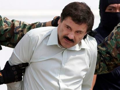 In this Feb. 22, 2014 file photo, Joaquin "El Chapo" Guzman, the head of Mexico's Sinaloa Cartel, is escorted to a helicopter in Mexico City following his capture in the beach resort town of Mazatlan, Mexico.