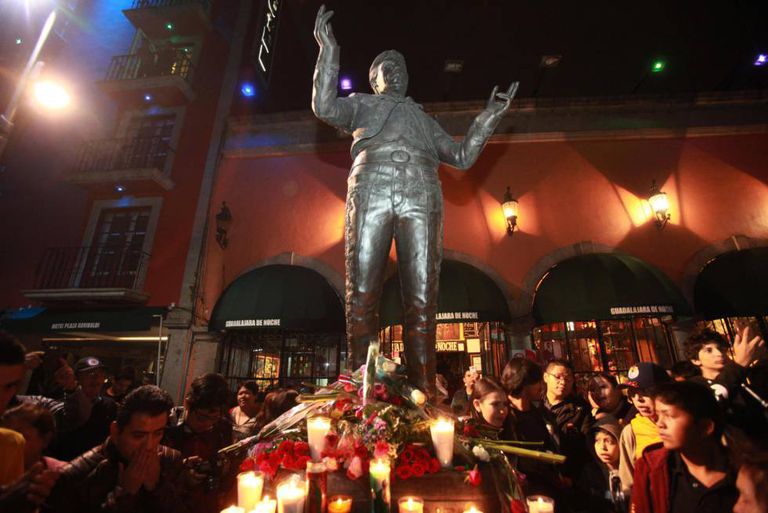 Hundreds of fans weeping and singing Juan Gabriel songs under his sculpture, in the Plaza Garibaldi in Mexico City.