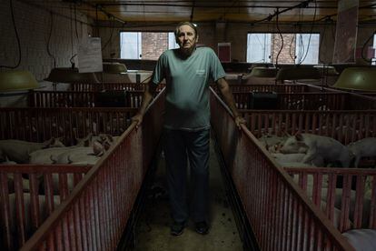 Milton Becker – a Bolsonaro supporter – poses for a photo on his pig farm in Quatro Pontes