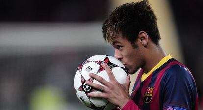 Barcelona forward Neymar kisses the match ball after his hat-trick against Celtic. 