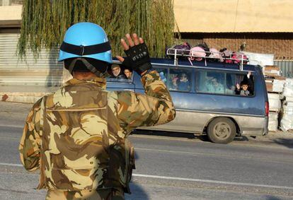 A Unifil soldier waves to a school bus in the south of Lebanon in December.