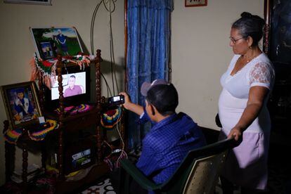 Socorro Leiva watching news about her daughter on TV.