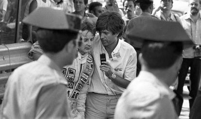 The winner of the Grand Prix, Ferrari driver Gilles Villeneuve, is interviewed by a journalist, in the presence of two Civil Guard officers. Villeneuve, who had a slight frame already, lost four kilos of weight during the Grand Prix.