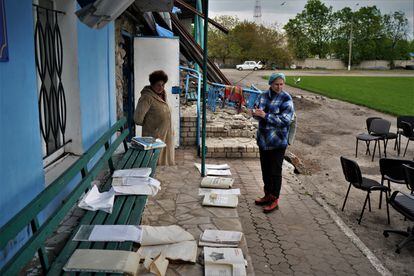 Svetlana, 55 (r), and Veronika, 63, dry documents rescued from the Kupiansk History Museum.