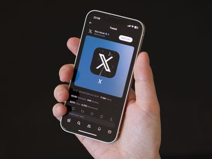 The X (formerly Twitter) logo is displayed on a cell phone.