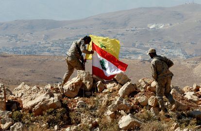 Hezbollah fighters put Lebanese and Hezbollah flags at Juroud Arsal, Syria-Lebanon border, July 25, 2017.