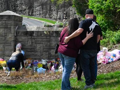 People gather at an entry to Covenant School which has become a memorial for shooting victims, on March 28, 2023, in Nashville, Tennessee.