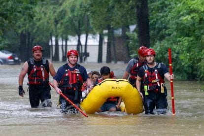 Firefighters help residents of Balch Springs, Dallas, who were trapped by the flash flooding.