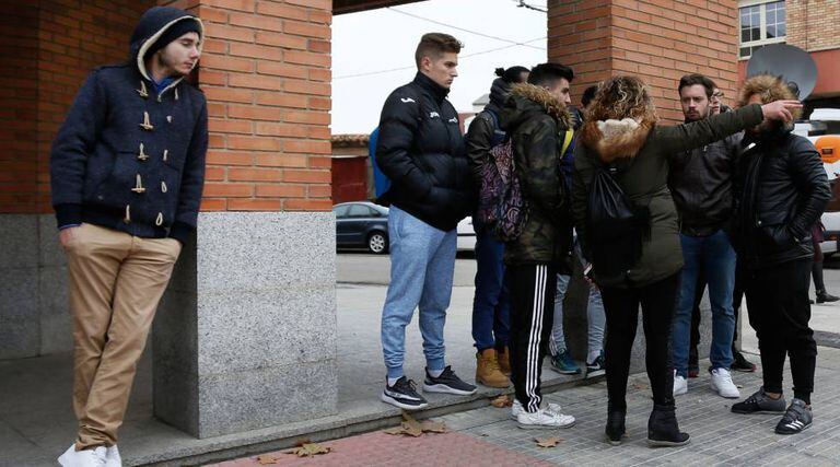 People wait outside the home of the accused soccer players on December 13.