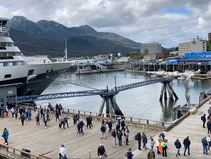 Passengers disembark from a cruise ship that has docked on June 12, 2023, in downtown Juneau, Alaska.