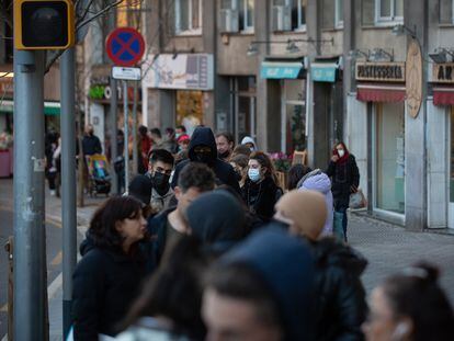 People wait in line for a Covid test outside a private clinic in Barcelona.