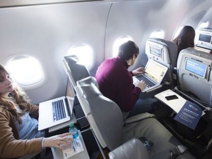 Journalists trying wi-fi service aboard a JetBlue airplane.