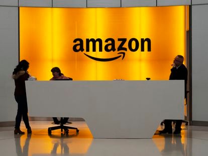 People stand in the lobby for Amazon offices in New York.