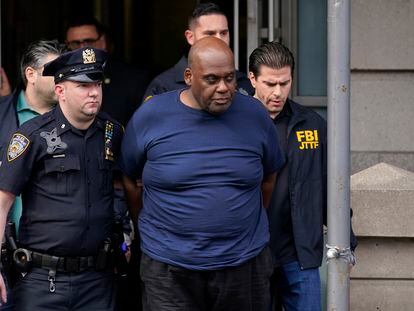 New York City Police and law enforcement officials lead subway shooting suspect Frank James, center, away from a police station in New York on April 13, 2022.