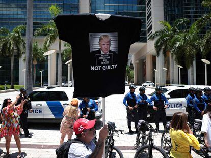 A Donald Trump supporter holds a T-shirt with an effigy of the former president with "Not Guilty" written on it, outside the Miami courthouse where the ex-president was arraigned on Tuesday.