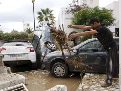 A resident of Vera, Almeria tries to clean up outside his house. 