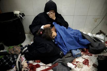 A woman hugs her daughter who was injured in Israeli shelling, at the Nasser hospital in Khan Younis, January 22.