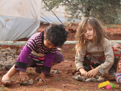 Two young girls playing near their tent in northwestern Syria.