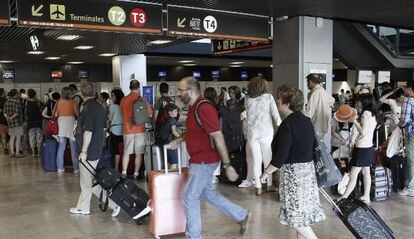 Travelers at Madrid’s Barajas airport.