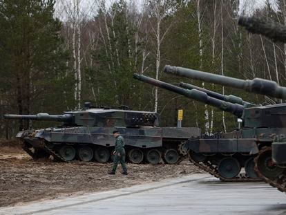 A Polish soldier walks next to Leopard 2 tanks during a training that is part of the EU's military assistance to Ukraine.