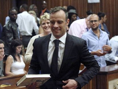 Oscar Pistorius reacts after he was granted bail as he leaves the North Gauteng High Court in Pretoria, South Africa after his bail hearing December 8, 2015.