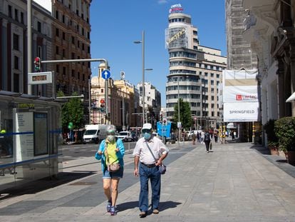 Passers-by with face masks on Madrid's Gran Vía earlier this month.