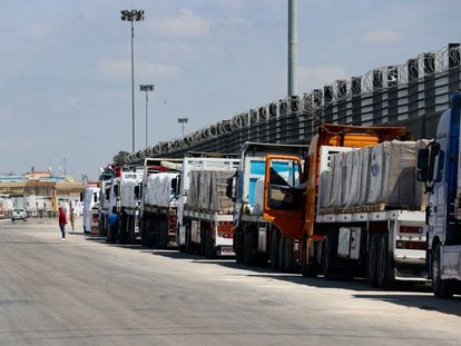 A line of trucks waits at the Egyptian side of the Rafah border crossing, which links Gaza to Egypt, March 23, 2024.