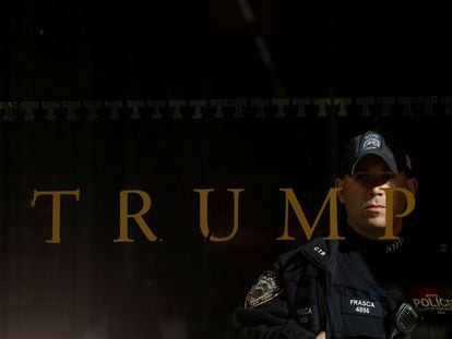 A police officer stands guard inside Trump Tower in Manhattan on Friday.