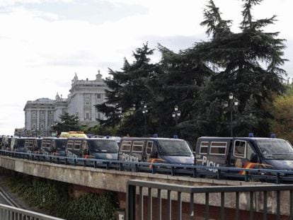 Police riot vans line the access road to the royal palace in Madrid Saturday. 