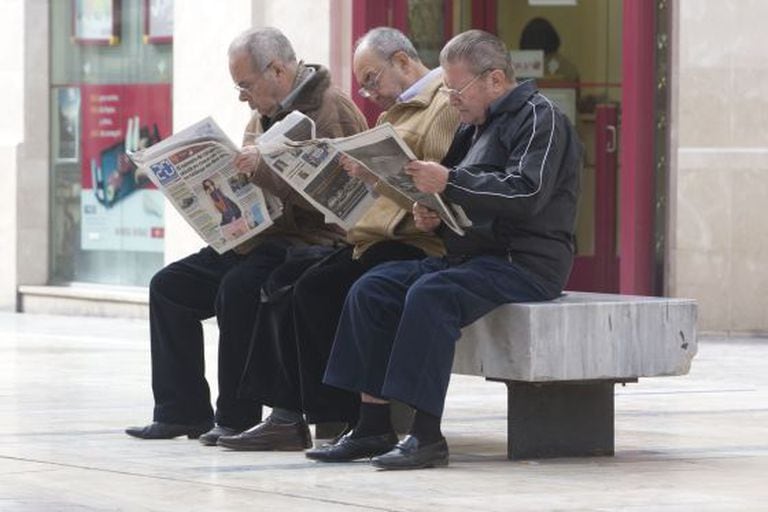 Pensioners reading newspapers in Málaga.