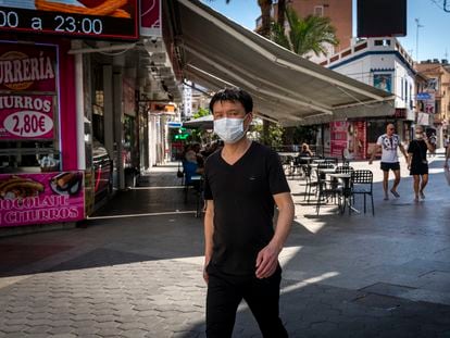 A pedestrian with a mask in Benidorm, a popular tourist destination on Spain’s eastern coast.