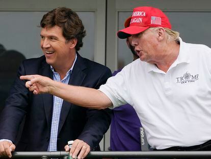 Tucker Carlson and former president Donald Trump, watch golfers during the final round of the LIV Golf Invitational at Trump National in Bedminster, New Jersey, in July 2022.