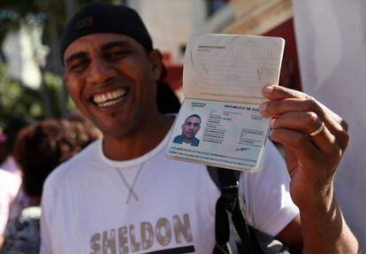 A man shows off his passport in Havana.