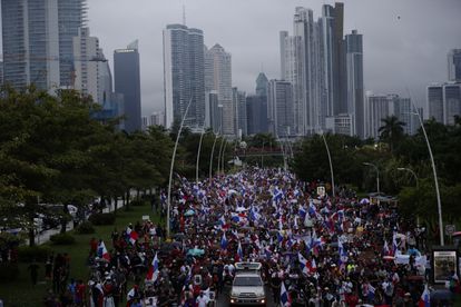 Demonstrators march through the streets of Panama City in the rain on October 26.