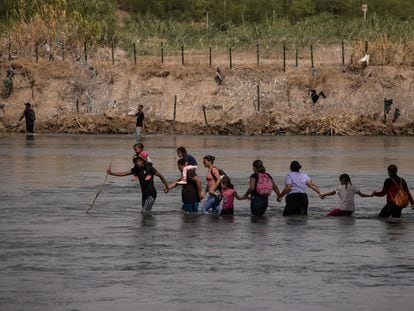 A group of immigrants cross the Rio Grande at Eagle Pass, Texas, on September 15.