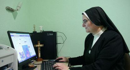 Blanca Alonso, who trains novices for the Servants of Jesus in Madrid, looks at the community's Facebook page.