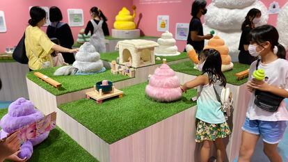 A group of visitors view an exhibit at Tokyo’s poop museum.