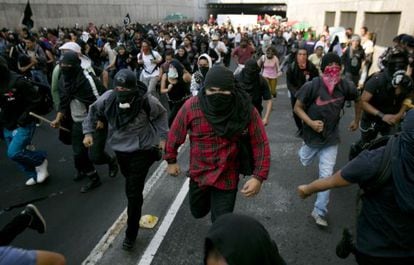 Masked demonstrators at a protest on October 2, 2013 in Mexico City.